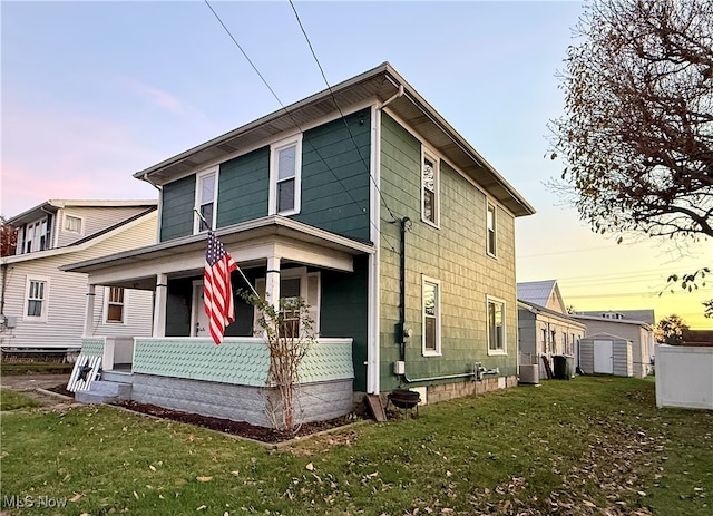 view of front facade with a porch and a yard