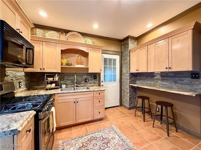 kitchen featuring sink, light brown cabinets, ornamental molding, stainless steel range with gas cooktop, and decorative backsplash