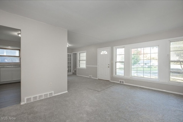 unfurnished living room featuring carpet