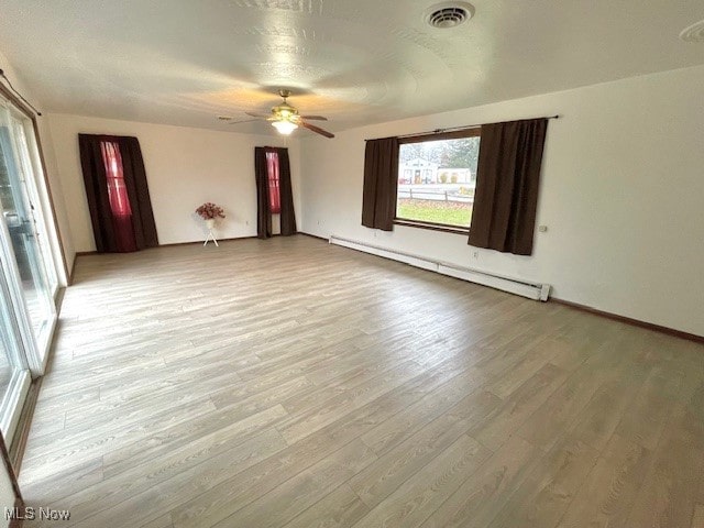 unfurnished room featuring a baseboard radiator, light hardwood / wood-style flooring, and ceiling fan