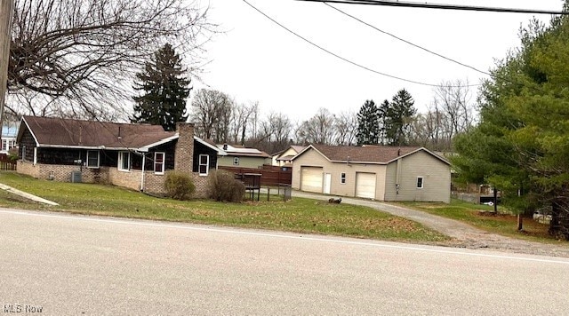 single story home featuring a garage and a front yard