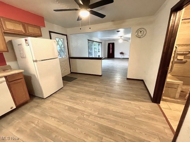 kitchen featuring ceiling fan, white appliances, and light hardwood / wood-style flooring