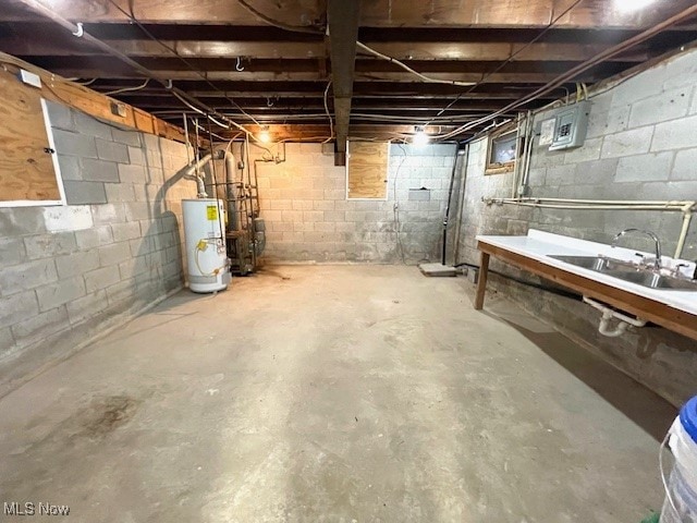 basement featuring gas water heater and sink