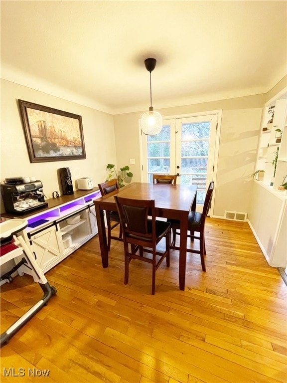 dining area with french doors and light wood-type flooring