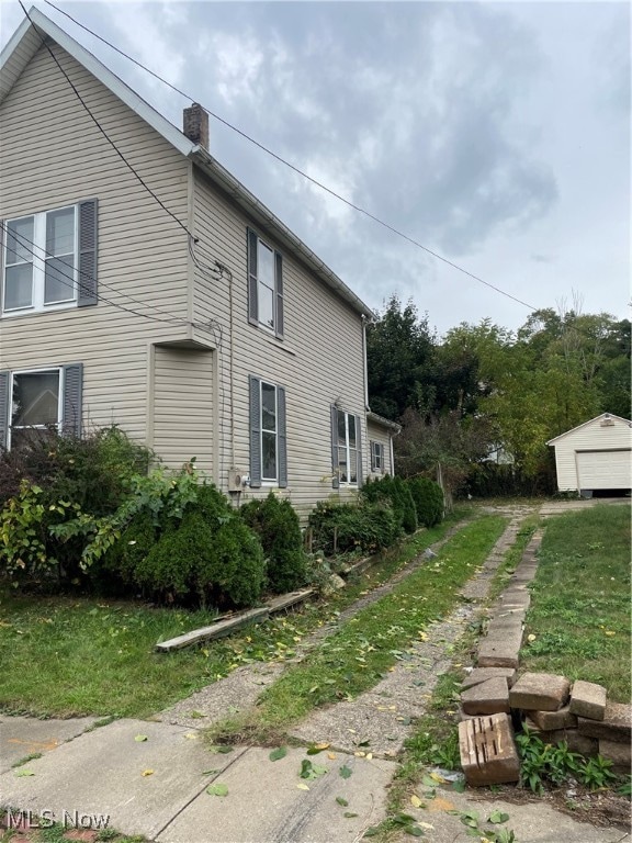 view of property exterior featuring a lawn