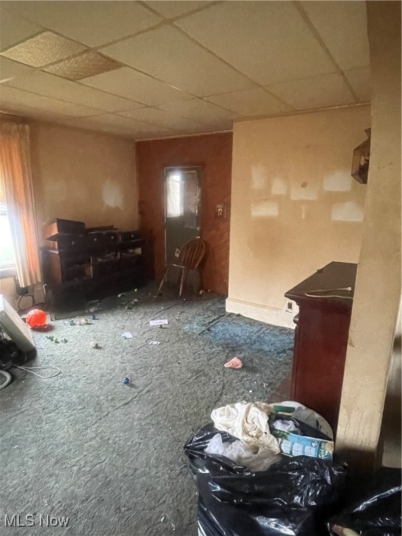 miscellaneous room with a paneled ceiling and carpet