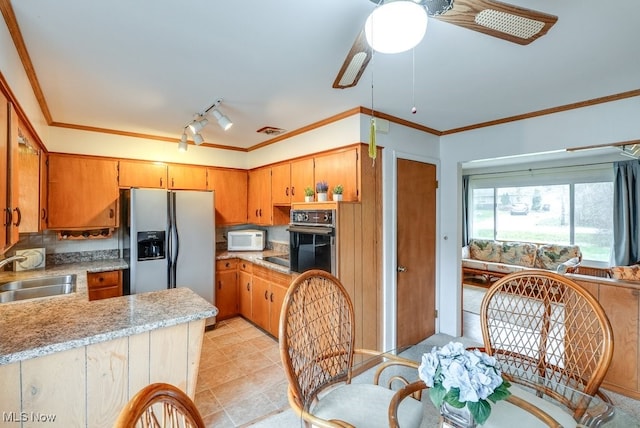 kitchen with ornamental molding, ceiling fan, sink, stainless steel fridge with ice dispenser, and black oven