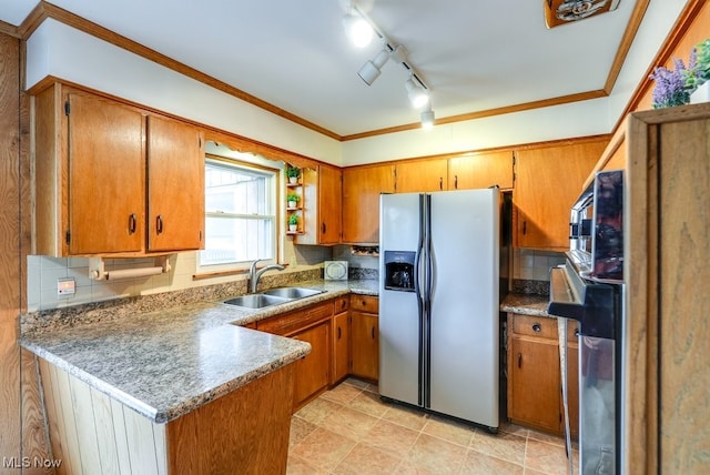 kitchen with stainless steel fridge, kitchen peninsula, sink, and tasteful backsplash