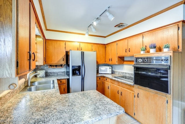 kitchen featuring sink, kitchen peninsula, track lighting, black appliances, and ornamental molding