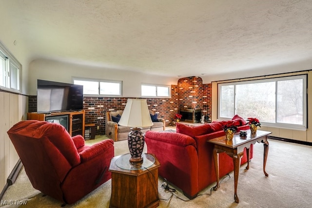 living room with light carpet, a textured ceiling, and a brick fireplace