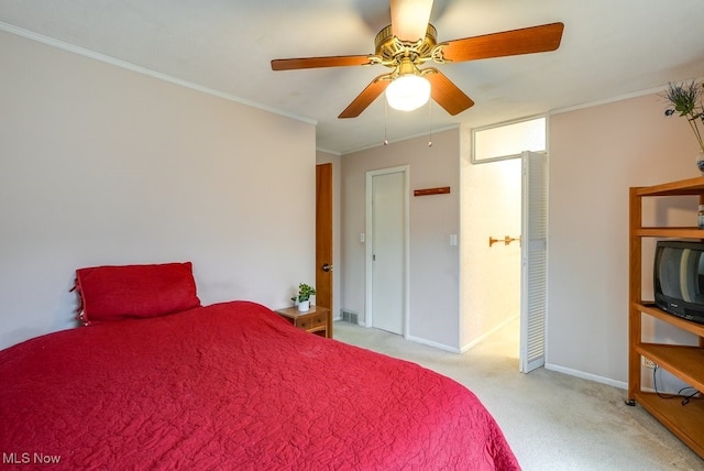 carpeted bedroom featuring ceiling fan and ornamental molding