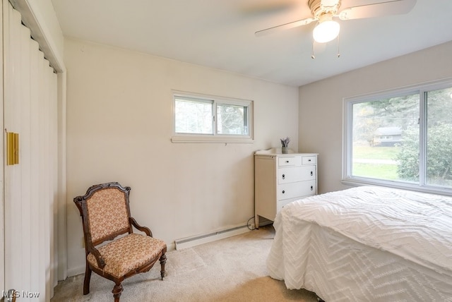 bedroom featuring ceiling fan, a baseboard heating unit, light carpet, and multiple windows