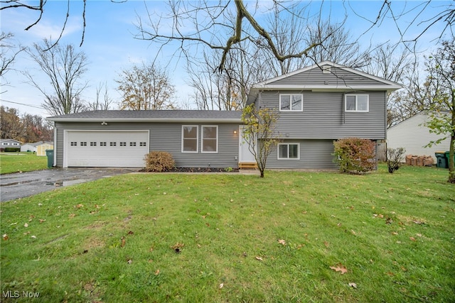 split level home featuring a front lawn and a garage