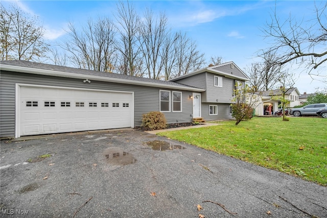 split level home with a garage and a front yard