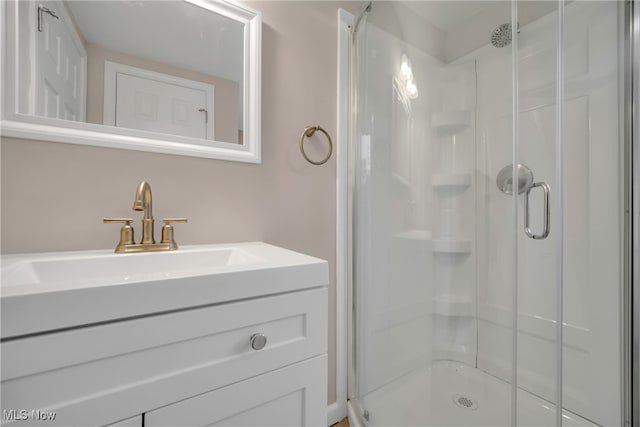 bathroom with vanity and a shower with door