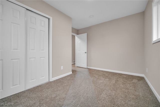 unfurnished bedroom featuring a closet and carpet floors