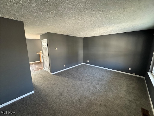 carpeted spare room featuring a textured ceiling