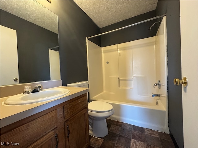 full bathroom featuring shower / bathing tub combination, vanity, a textured ceiling, and toilet