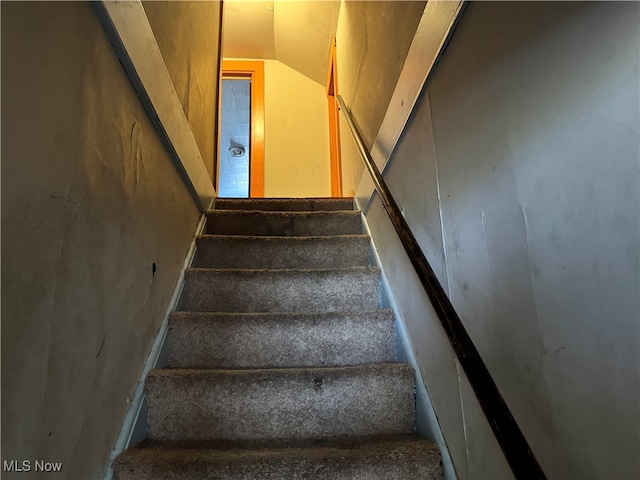 stairway featuring lofted ceiling