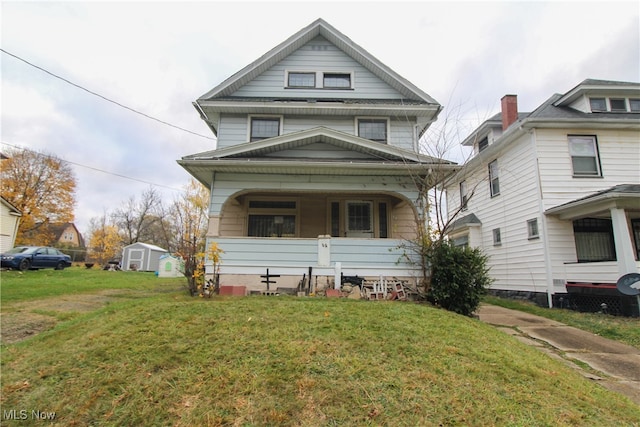 view of front of home featuring covered porch and a front lawn