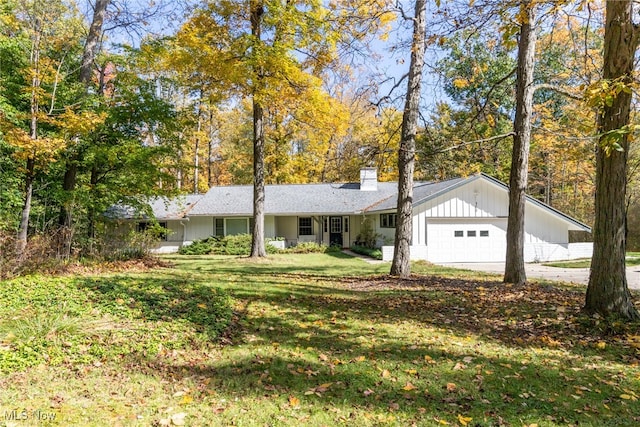 single story home with a garage and a front yard