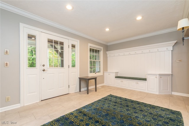 entryway featuring light tile patterned flooring, a textured ceiling, and ornamental molding