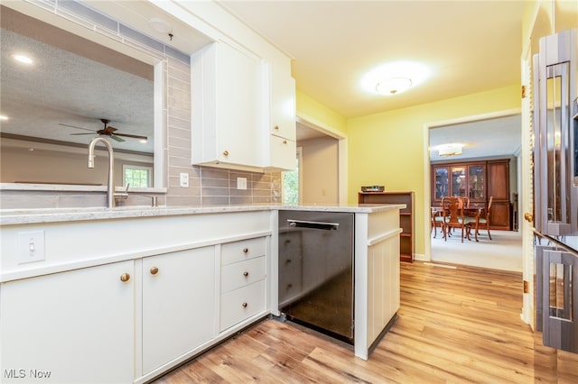 kitchen with white cabinets, ceiling fan, tasteful backsplash, light hardwood / wood-style floors, and kitchen peninsula