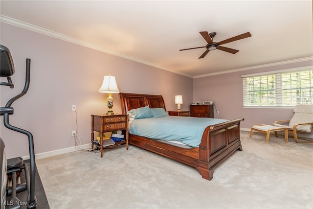 carpeted bedroom featuring ceiling fan and crown molding