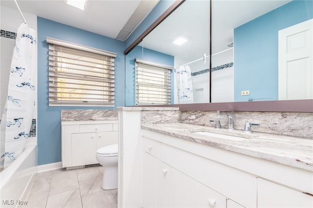 full bathroom featuring tile patterned floors, vanity, toilet, and shower / bathtub combination with curtain