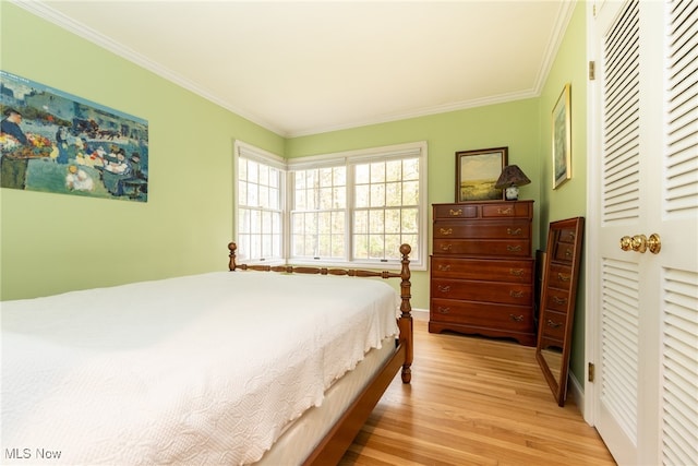 bedroom with light hardwood / wood-style flooring and ornamental molding