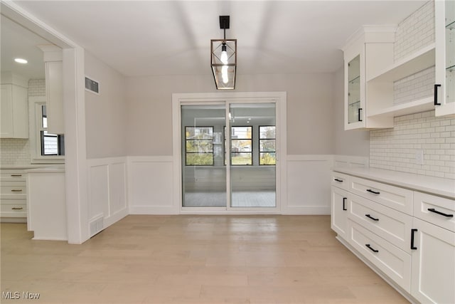 unfurnished dining area featuring light hardwood / wood-style floors