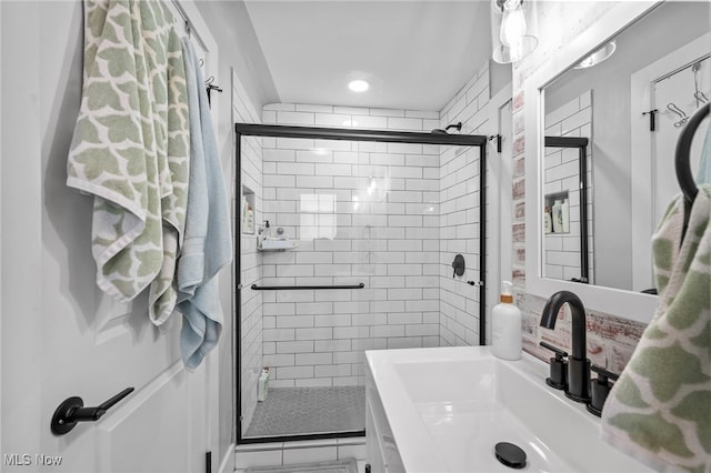 bathroom featuring walk in shower and sink