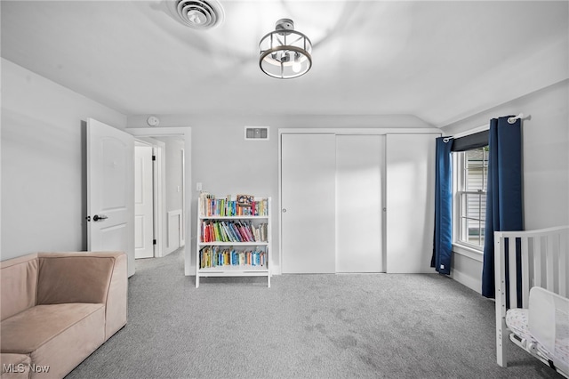 bedroom featuring vaulted ceiling, carpet floors, and a closet