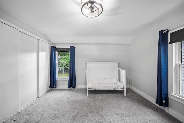 unfurnished room with carpet floors and vaulted ceiling