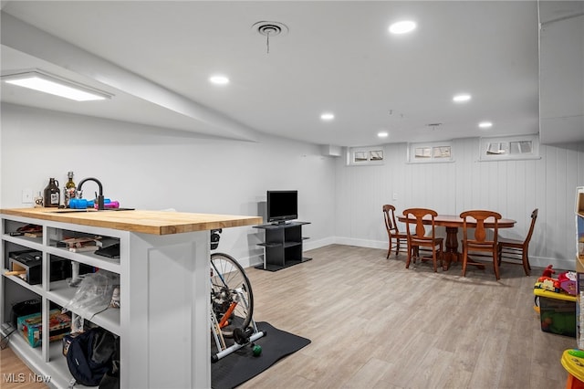 interior space featuring wooden walls and light hardwood / wood-style floors