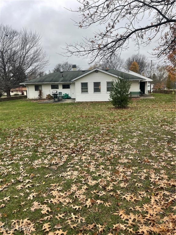 view of side of home featuring a yard