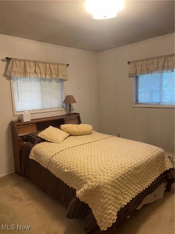 bedroom featuring light carpet