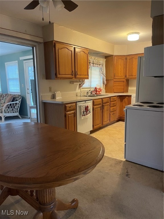 kitchen featuring stove, stainless steel dishwasher, light colored carpet, ceiling fan, and fridge