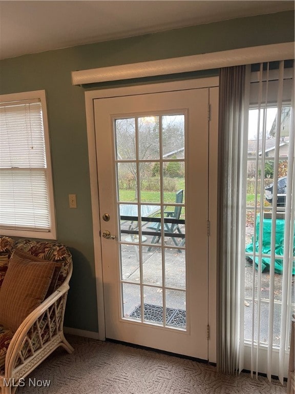 doorway to outside with carpet