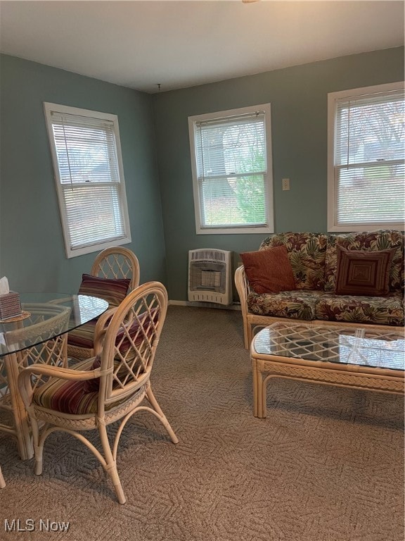 dining area featuring heating unit, carpet, and a healthy amount of sunlight