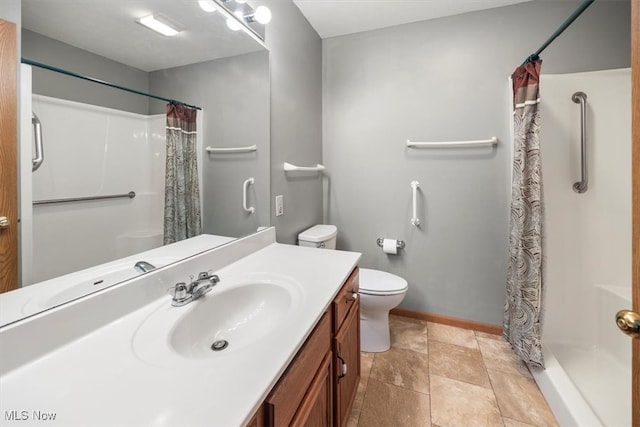 bathroom featuring vanity, curtained shower, and toilet