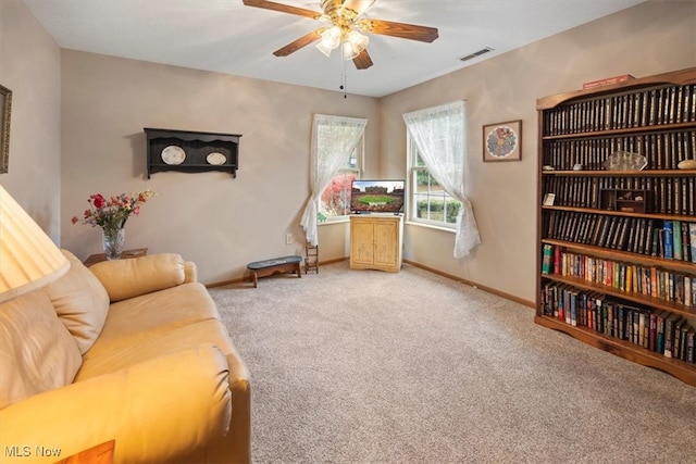 living area featuring ceiling fan and carpet floors