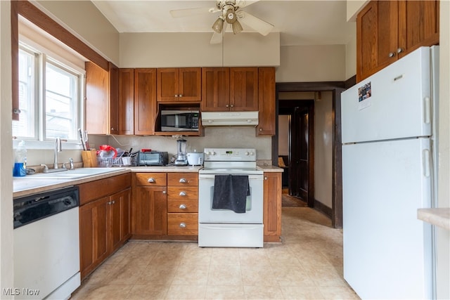 kitchen featuring white appliances, ceiling fan, and sink