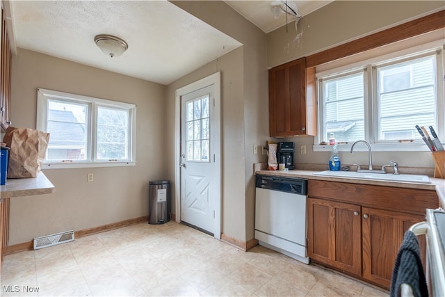 kitchen with dishwasher, range, and sink