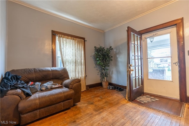 living room with hardwood / wood-style floors and ornamental molding