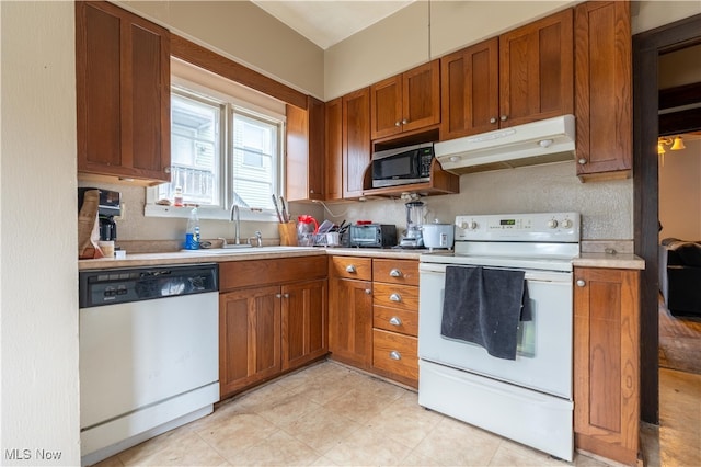 kitchen with sink and white appliances