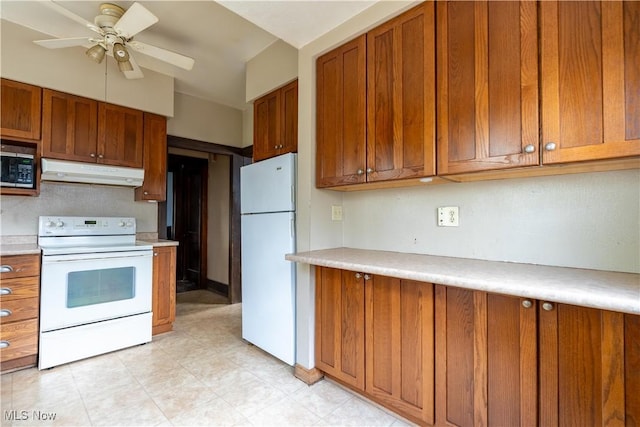 kitchen with a ceiling fan, brown cabinetry, white appliances, light countertops, and under cabinet range hood