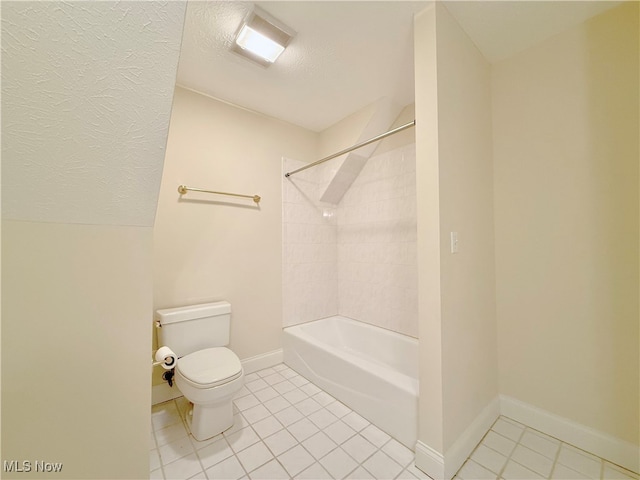 bathroom with tile patterned floors, tiled shower / bath combo, and toilet