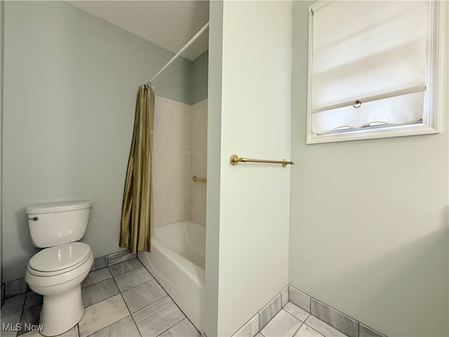 bathroom with tile patterned floors, shower / bath combo, and toilet