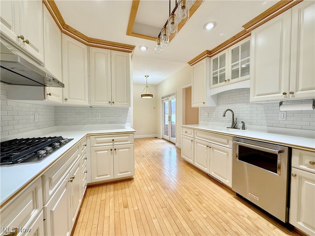 kitchen featuring sink, hanging light fixtures, stainless steel dishwasher, decorative backsplash, and gas stovetop